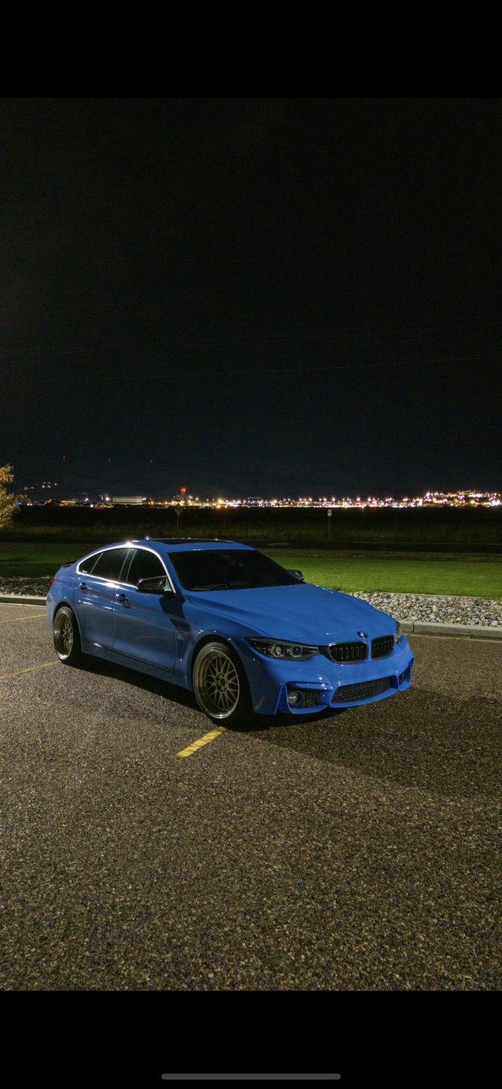 Blue BMW sedan at night